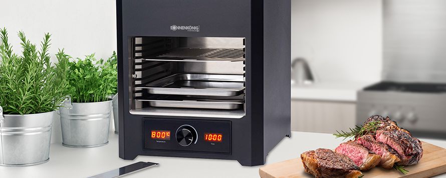 Electric grill on table with piece of meat next to it mood picture